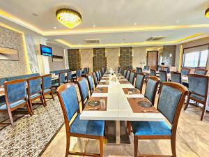 a long dining room with a long table and chairs at White Season by The Sky Imperial, Bhilwara in Bhilwara