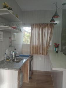 a kitchen with a sink and a counter top at Recanto das Videiras in Maria da Fé