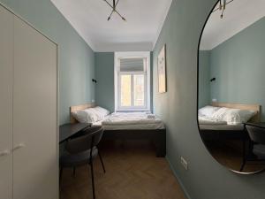 a small room with two beds and a mirror at Malfatti Room Oasis Space in Vienna