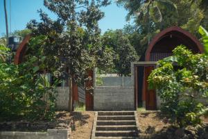 a small church with stairs leading to a door at Rinjani Koceng Bungalows in Tetebatu +28 photos