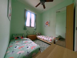 a bedroom with two beds and a table in it at The Red House in Hong Kong +4 photos