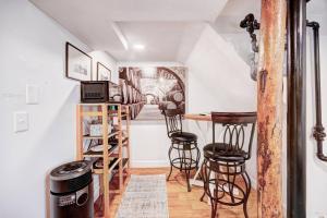 a room with a table and stools in a room at Eagle's Landing - Logan Airport in Boston