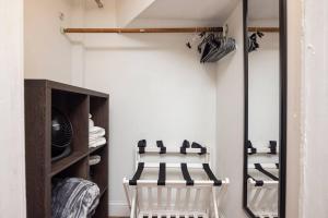 a room with a closet with a chair in it at Eagle's Landing - Logan Airport in Boston +14 photos