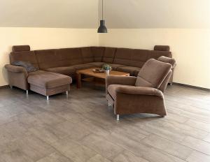 a living room with a couch and chairs and a table at Ferienwohnung Jasi, OG 95174 in Rhauderfehn