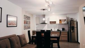 a living room and kitchen with a couch and a table at Casa Nostra in Quito