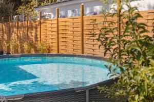 a swimming pool in front of a wooden fence at Estudio Limón y Sal in Chiclana de la Frontera +16 photos