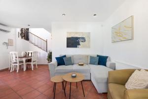 a living room with a couch and a table at ALBA by the Sea in Punta Prima