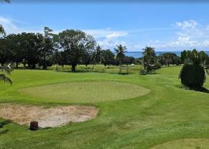 a view of a golf course with a green field at Faith Accommodation in Apia