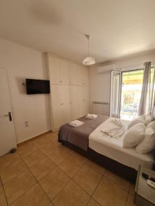 a bedroom with a large bed and a window at The Hammam Guest House in Nydri