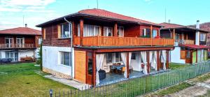 a house with a fence in front of it at Villa Nikol Apt #1 in Raduil