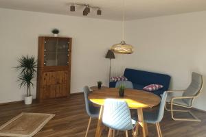a living room with a table and a blue couch at Ferienwohnung in Sankt Wendel in Sankt Wendel +2 photos
