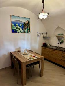 a kitchen and dining room with a wooden table at Casa Vacanza L'Aurora in Vico Equense +1 photo