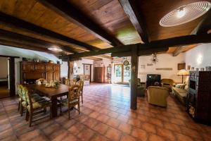 a dining room and living room with a table and chairs at Statek Vranč - stodola in Bítov