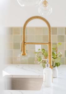 a sink with a faucet and a bottle of soap at Huge Modern Chalet on Trestle Trail New Paltz & Rosendale in Rosendale