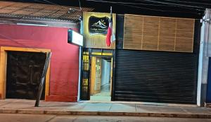 a building with a sign on the side of it at Lodge Atacama Hostal in Copiapó