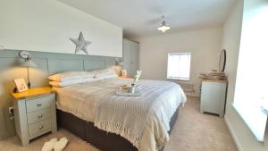 a bedroom with a large bed with a star on the wall at Seabreeze Cottage 2 bedroom - Sleeps 6 - Bron-Y-Wendon Holiday Park in Llanddulas +10 photos
