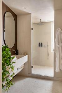 a bathroom with a shower and a sink and a mirror at NAMAN HOTELLERIE - Condotti in Rome