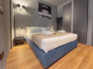 a bedroom with a bed with two towels on it at Blu Rooms - Rooms to Rest by Host Hero in Civitanova Marche