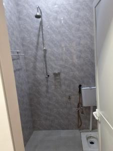 a bathroom with a shower with a toilet at Adriel House in Dodoma