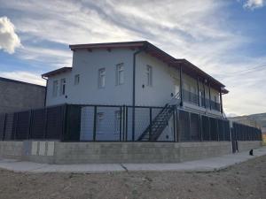 a white building with a staircase on the side of it at Patagonia Cordilleras in Esquel