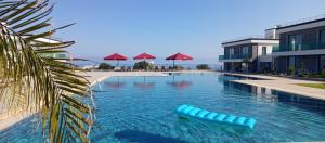 a swimming pool with a blue raft in the water at Sunprime Premium Site in Pyla
