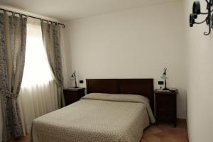 Postel nebo postele na pokoji v ubytování Hotel Il Ghiro