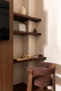 a dining room with two chairs and a table at NAMAN HOTELLERIE - Condotti in Rome