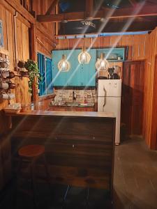 a kitchen with a counter and a refrigerator at Casa de Praia Dunnas - Ajuruteua - Pa in Bragança