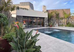a swimming pool in front of a house at Porta Celeste in Mosteiros