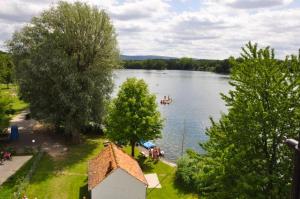 a view of a lake with a boat in the water at Freistehendes Haus mit grossem Garten zur alleinigen Nutzung in Großkrotzenburg