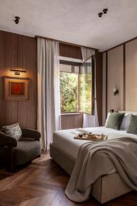 a bedroom with a large bed and a window at NAMAN HOTELLERIE - Condotti in Rome