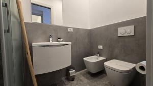 a bathroom with a toilet and a sink at LA PIAZZETTA - Homy 5 Terre in Volastra +45 photos