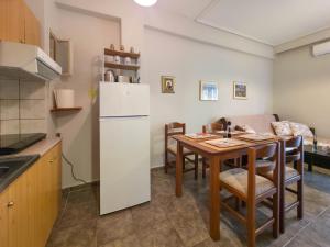 a kitchen and dining room with a table and a refrigerator at Emily's Paradise by SDR in Paralia Katerinis +10 photos