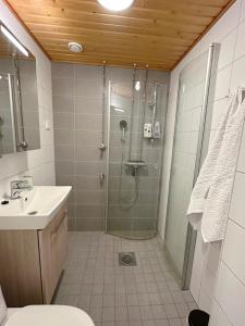 a bathroom with a shower and a sink at Bright & Cozy 1BR Home in Central Lahti in Lahti