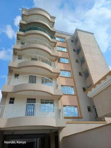 a tall building with a balcony on the side of it at Colokhaly Apartment in Nairobi