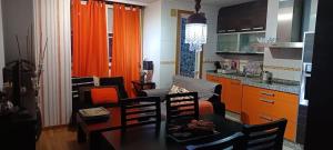 a kitchen and a living room with a table and chairs at Cozy apartment in Orense of 45 m² with parking in Ourense