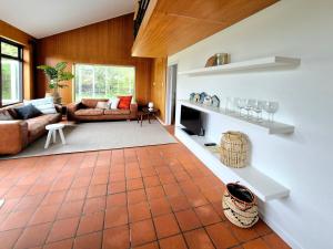 a living room with a couch and a fireplace at de Brabander in Cadzand