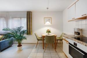 a kitchen with a table and chairs and a dining room at Ferienwohnung Matt in Todtmoos