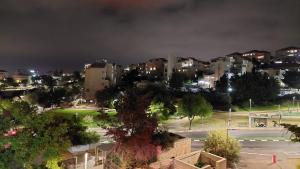 a view of a city at night at Luxe on Dolev in Beit Shemesh