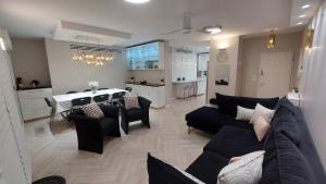 a living room with a couch and a dining room at Luxe on Dolev in Beit Shemesh