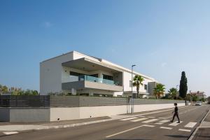 a person walking down a street in front of a building at Villa Fasana-Apartment 5 by Vivi Rent in Fažana