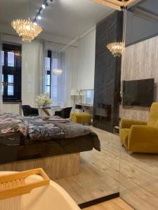 a bedroom with a bed and a living room at Lux Dabich 1 in Novi Sad