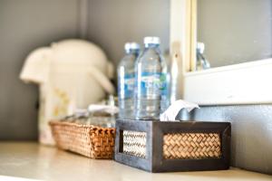 two bottles of water and two baskets on a counter at Dang Sea Beach Resort - SHA in Nai Yang Beach