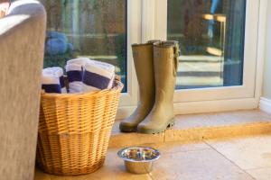 a pair of boots sitting next to a window at 2 Bed House with Hot Tub Great Ayton - TOP House in Great Ayton +16 photos