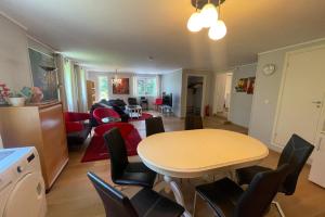 a kitchen and living room with a table and chairs at Spacious apartment with 4 bedrooms in Grimstad +15 photos
