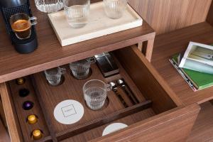 a wooden drawer with glasses on a table at NAMAN HOTELLERIE - Roma in Rome