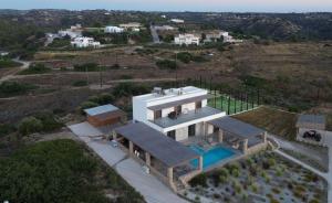 an aerial view of a house with a swimming pool at Villa Milan 1 mit Padelplatz in Kos