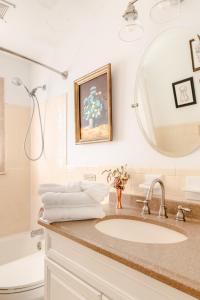 un bagno con lavandino e specchio di Cottage on King Charming Historic Leesburg Home a Leesburg Altre 35 foto