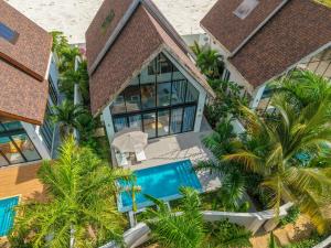 an aerial view of a house with a pool and palm trees at Emerald Villas by Paje Emerald Escapes Ltd in Paje