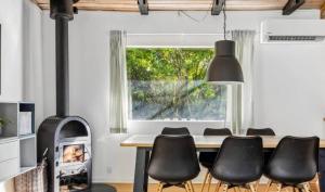a dining room with a table and chairs and a fireplace at 10041-1-Rorvig-Langesovej-2 in Rørvig